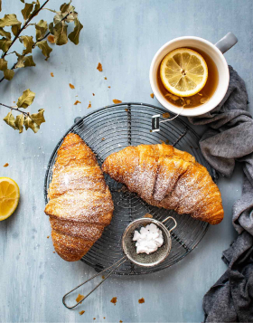 Tasty croissant and tea for perfect breakfast